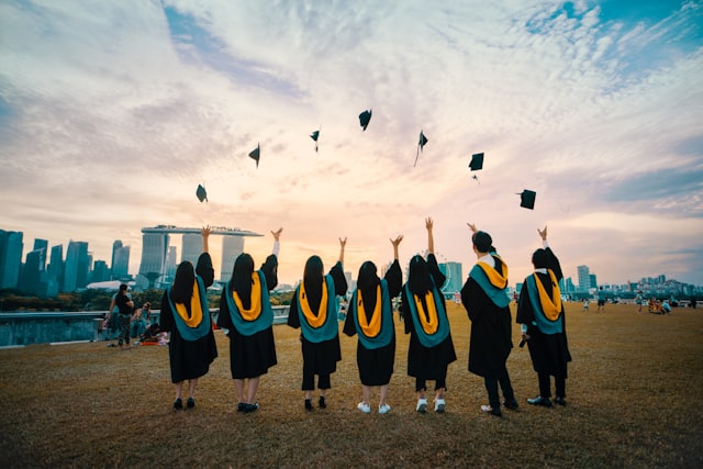 Graduates celebrating and tossing their caps in the air